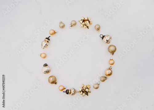 Flat lay of round frame of golden Christmas decorate on white background