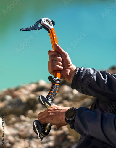 Climber with the ice ax in the mountains.
