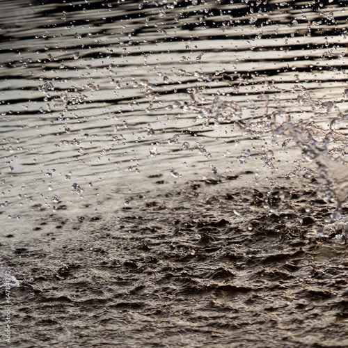 Background with splashes and drops of water in the lake, river or sea.