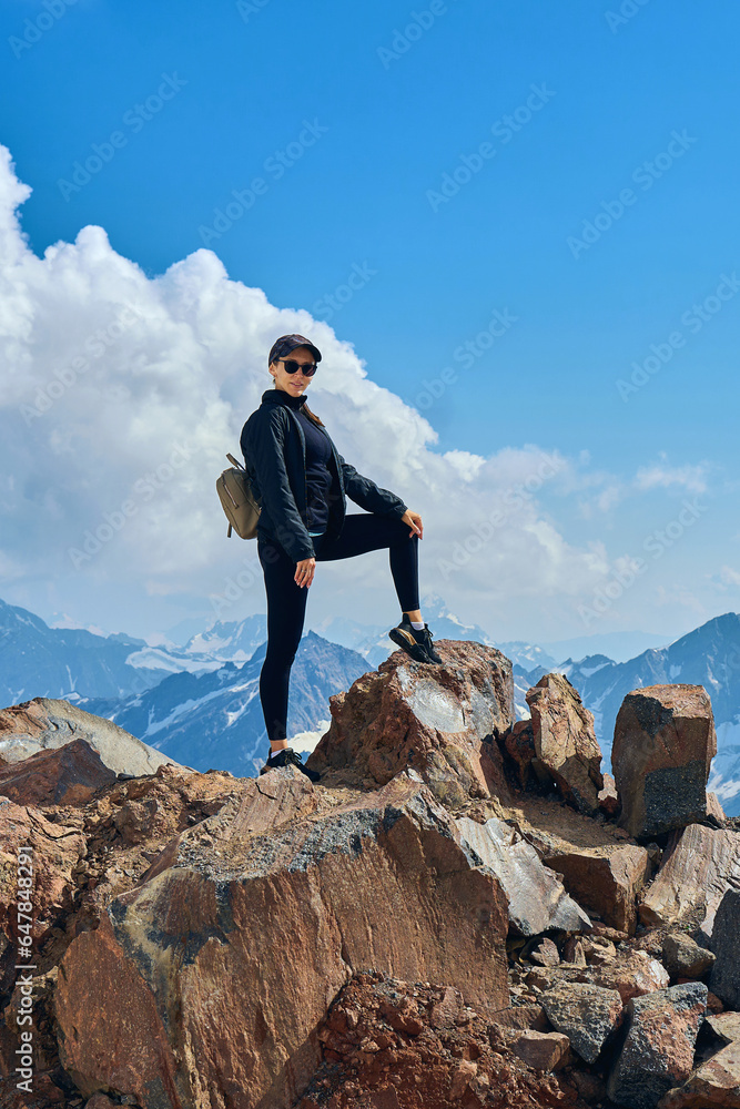 girl on top of snow-capped mountains
