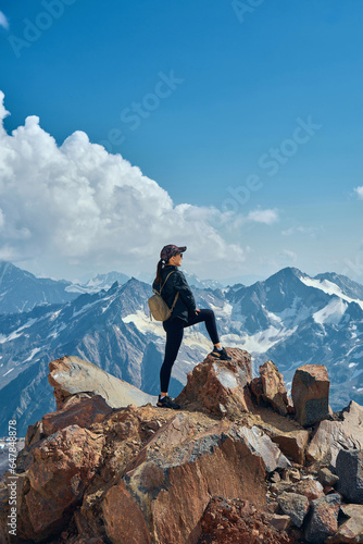 girl on top of snow-capped mountains