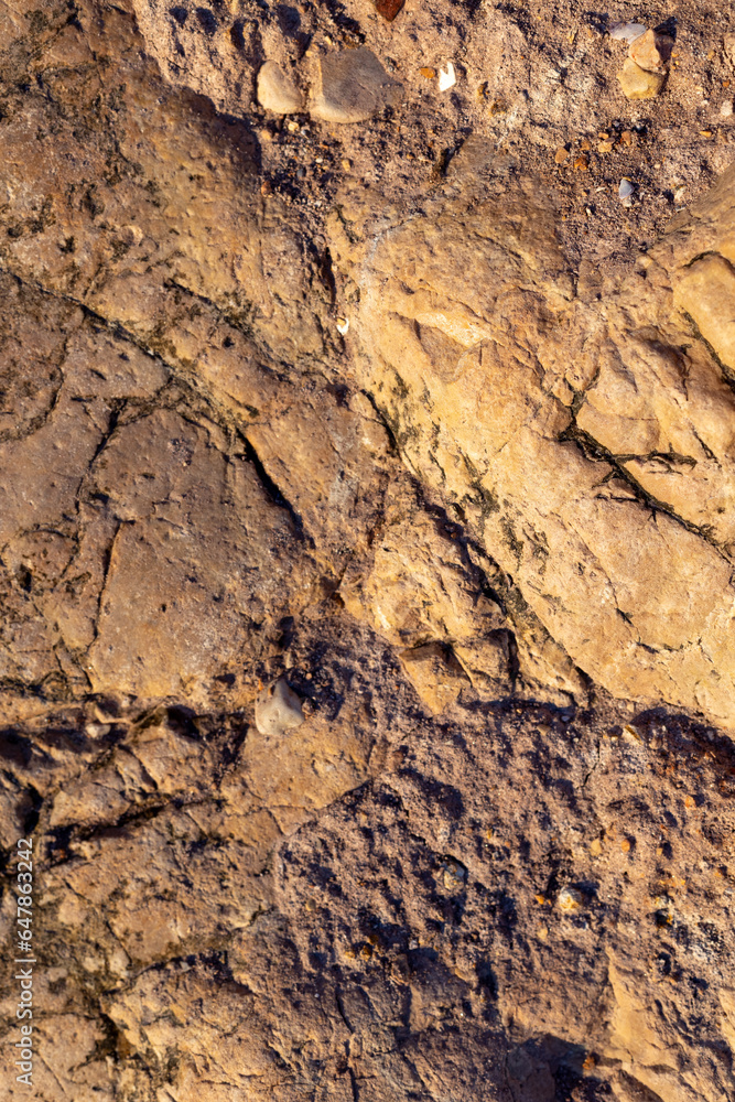 Cracked rock Texture. Stone surface with brown tint Cracked rock Texture. Stone surface with brown tint