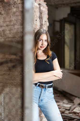 Photo of sensual young european woman inside of deserted building. Portrait of long haired tempting woman in abandoned house. © JackF