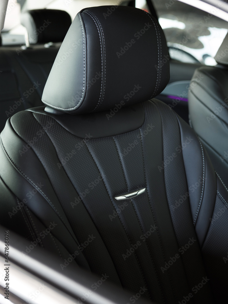 vertical photo of a luxurious black leather seat in a premium car