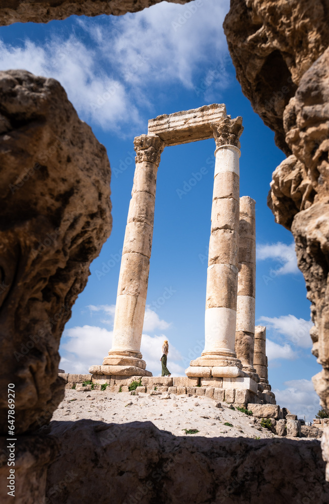 Travel blonde woman in the Temple of Hercules in Amman. Ancient Roman city in Jordan Travel blonde woman in the Temple of Hercules in Amman. Ancient Roman city in Jordan