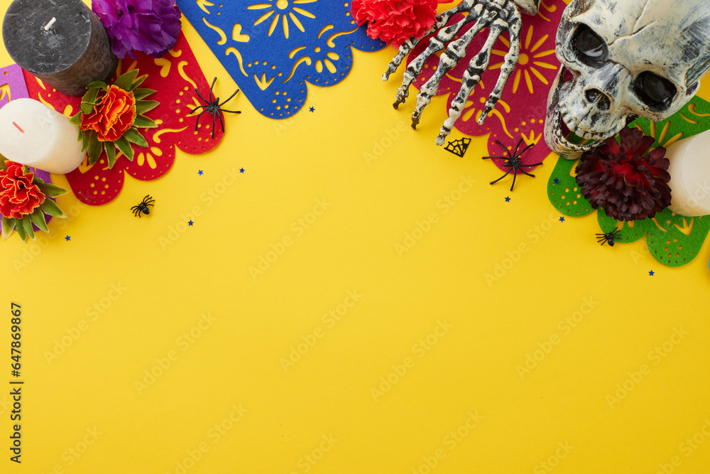 Embrace mexican traditions with joy. Top view of spooky skull, flowers, skeleton arm, candles, paper garland, scary insects on yellow background with empty space for promo or text
