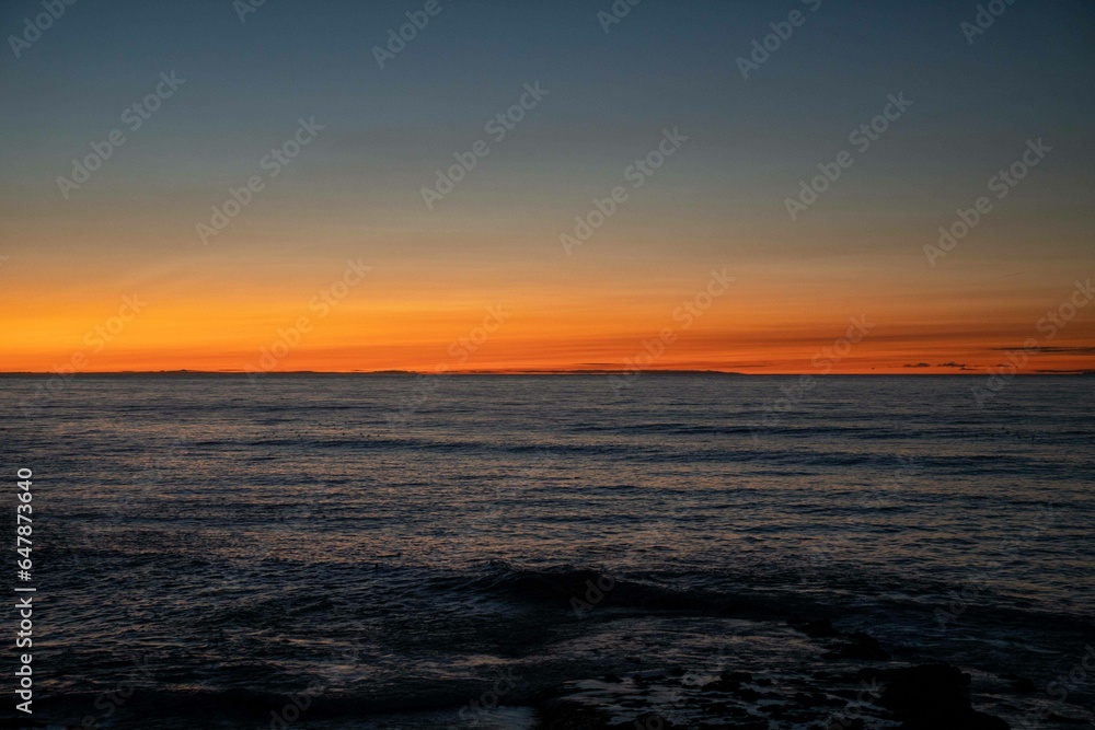 beautiful orange and blue background of a beach during the sunset in california on the west coast beautiful orange and blue background of a beach during the sunset in california on the west coast