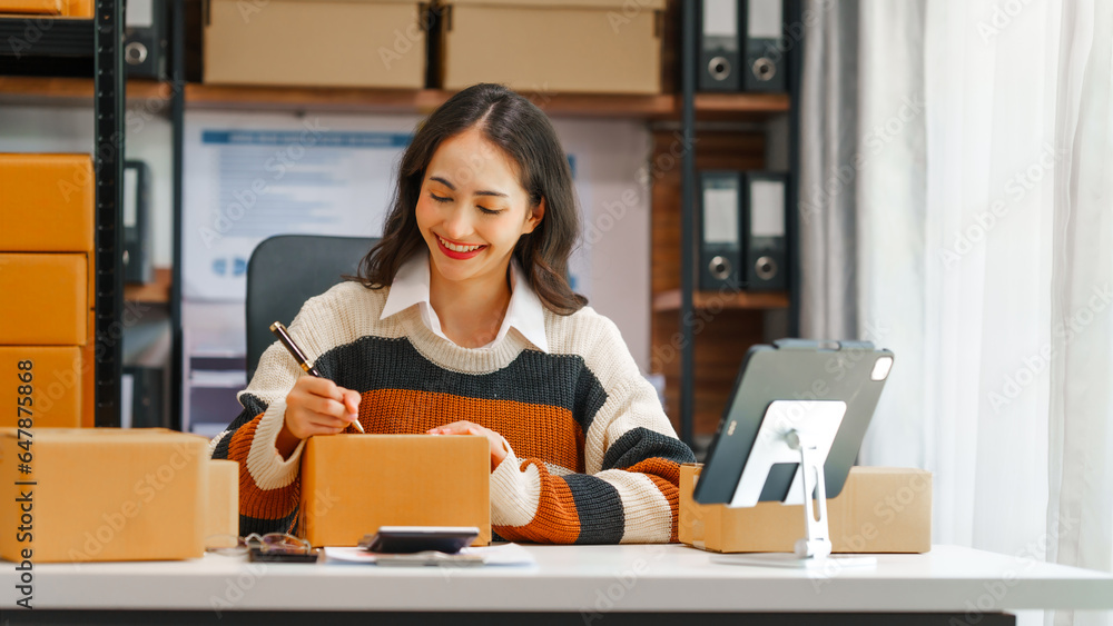 © NanSan - Portrait of Female Entrepreneur SME Management concept, Asian indian entrepreneur portrait showcasing hands-on involvement in her small business, including box management.
