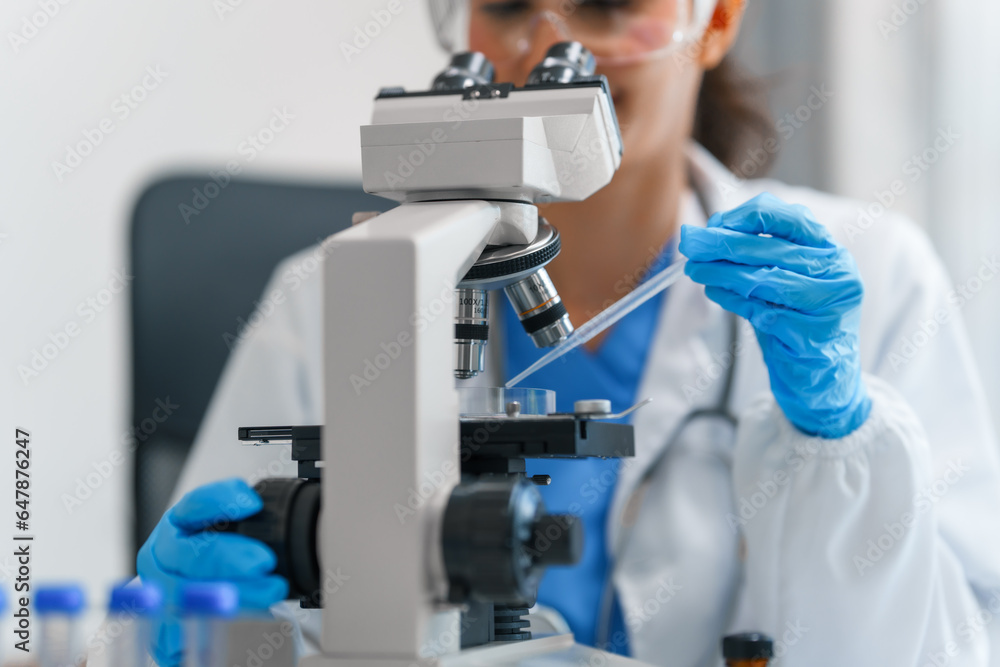 Young scientists pioneering medical discoveries in lab, with one scientist employing microscope for invaluable insights, blood lab test, virus vaccine invent, asian indian people Young scientists pioneering medical discoveries in lab, with one scientist employing microscope for invaluable insights, blood lab test, virus vaccine invent, asian indian people