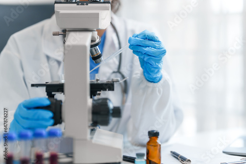 Young scientists pioneering medical discoveries in lab, with one scientist employing microscope for invaluable insights, blood lab test, virus vaccine invent, asian indian people