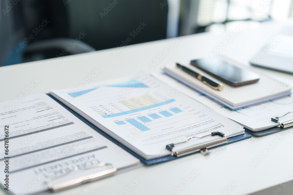 Office financial tools, close-up of calculator and financial chart on a clean desk. corporate finance workspace, uncluttered desk featuring business essentials for financial analysis. Office financial tools, close-up of calculator and financial chart on a clean desk. corporate finance workspace, uncluttered desk featuring business essentials for financial analysis.