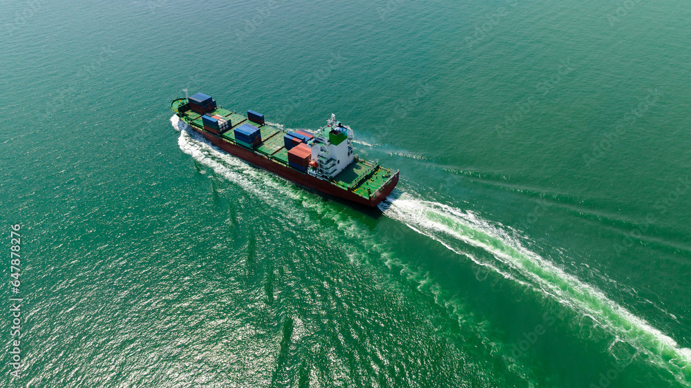 cargo container ship sailing full speed in sea to import export goods and distributing products to dealer and consumers worldwide, by container ship Transport business delivery service, aerial view cargo container ship sailing full speed in sea to import export goods and distributing products to dealer and consumers worldwide, by container ship Transport business delivery service, aerial view