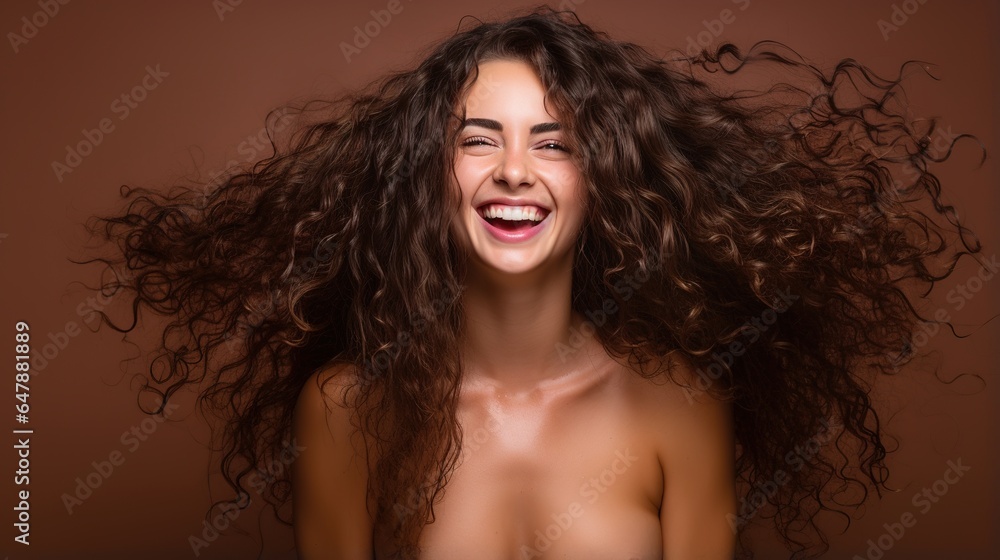 woman with lovely curly hair against a gray background. Beautiful girl with a cheerful smile. 