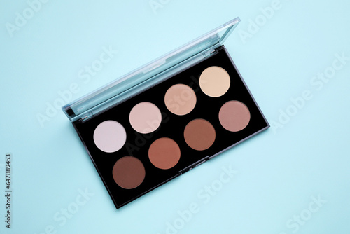 Colorful contouring palette on light blue background, top view. Professional cosmetic product © New Africa