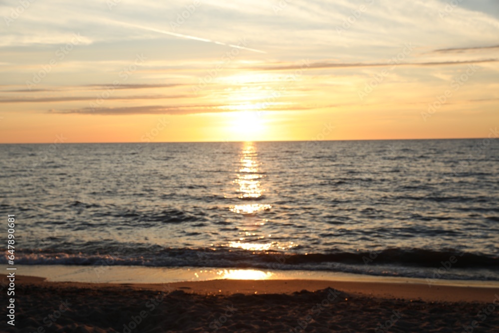 Blurred view of beautiful sea at sunset. Tropical beach