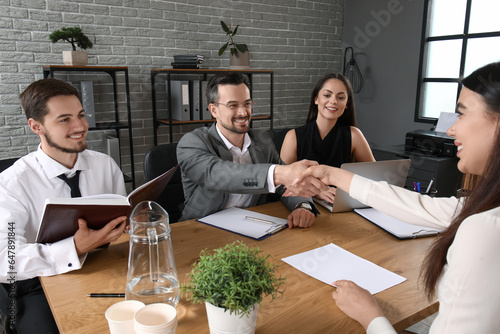 Slika na platnu Human resources manager shaking hands with female applicant in office