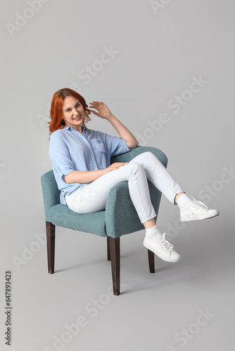 Young woman sitting in soft...