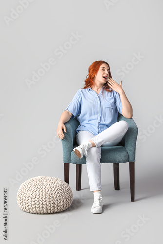 Young woman sitting in soft...