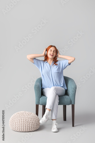 Young woman sitting in soft...