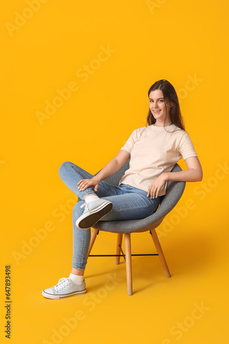 Young woman sitting in armc...