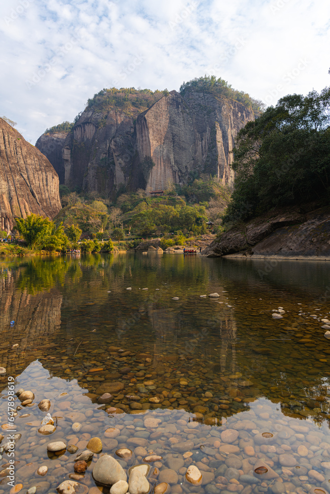 Rocks on the shore and strange shaped mountains of Wuyishan, China