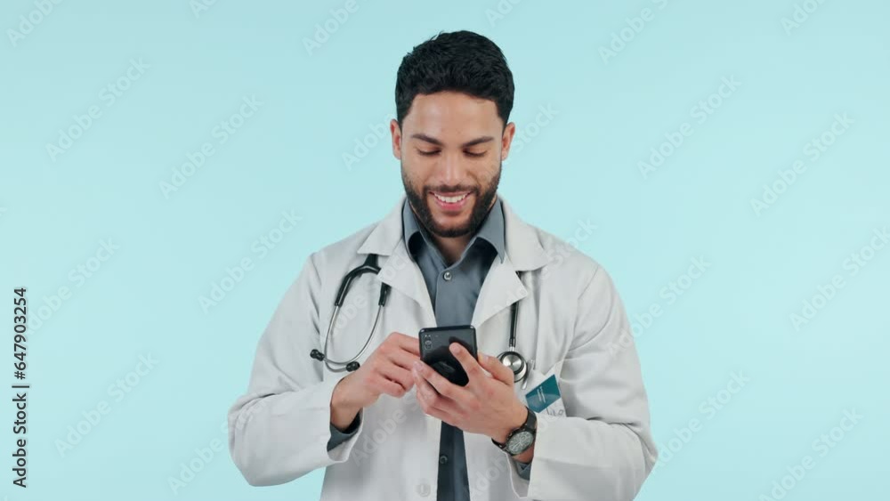 Medical doctor, phone or man typing in studio for communication, social media or email. Happy healthcare worker and smartphone on blue background for telehealth consultation, network scroll or search Medical doctor, phone or man typing in studio for communication, social media or email. Happy healthcare worker and smartphone on blue background for telehealth consultation, network scroll or search