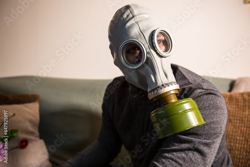 Civilian wearing nuclear gas mask during nuclear fallout and a time of war photo