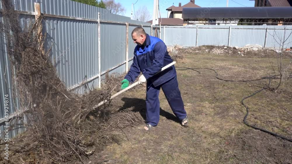 A man works in a vegetable garden in early spring A man works in a vegetable garden in early spring