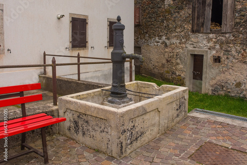 A drinking water fountain in the mountain village of Magnanins near Rigolato in Carnia, Friuli-Venezia Giulia, north east Italy. Located in Piazzetta Giacomo Giuseppe Pochero square, known as La Fonta photo