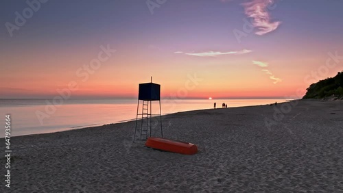 Sunriseat lifeguard hut and boat on beach by Sea photo