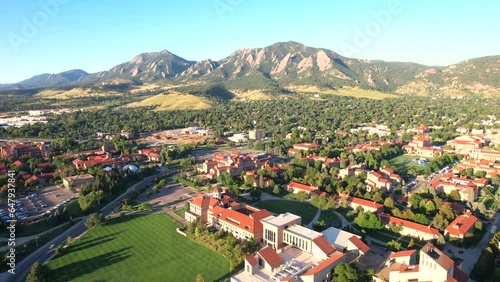 Drone flying the University of Colorado Boulder (CU Boulder), with the flatirons and the town of Boulder in the background. Colorado University Campus on a Summer morning. photo