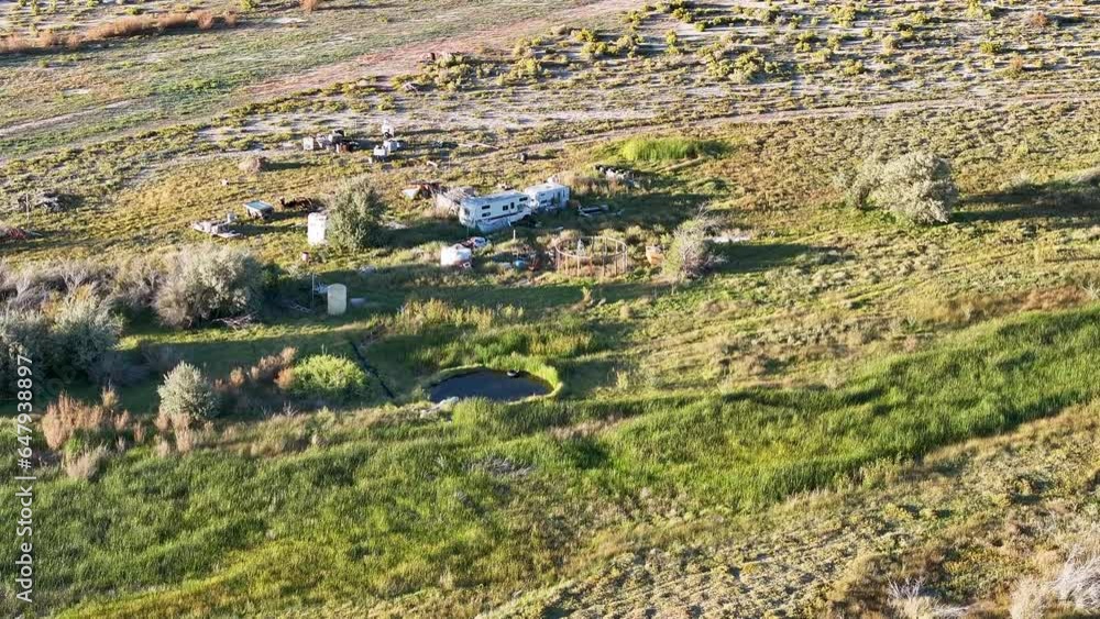 Aerial natural hot springs abandoned motorhome Utah desert. Dry rugged