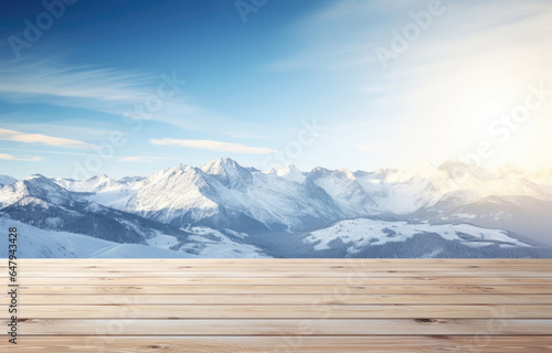 Empty wooden table with winter mountains and sky on background © Aleksandr Bryliaev