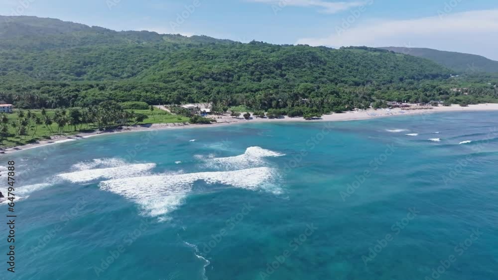 Waves crashing to tropical sand beach resort in El Quemaito, drone forward Waves crashing to tropical sand beach resort in El Quemaito, drone forward