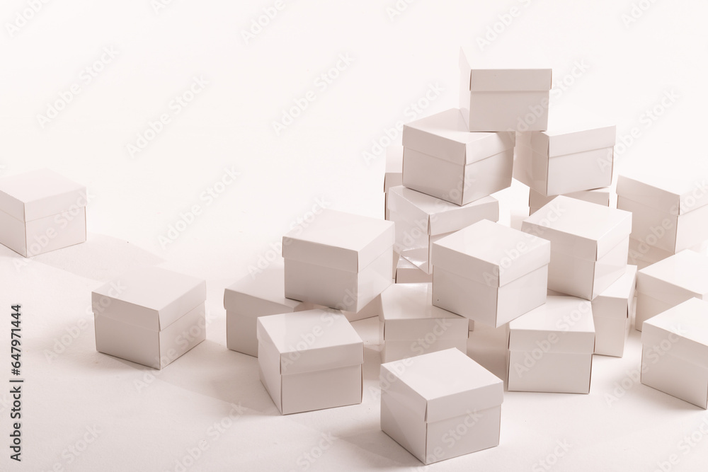 Stack of white gift boxes and copy space over white background Stack of white gift boxes and copy space over white background