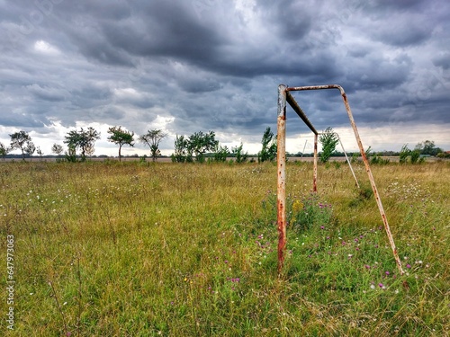 Abandoned soccer field under sky with stormclouds in Germany
