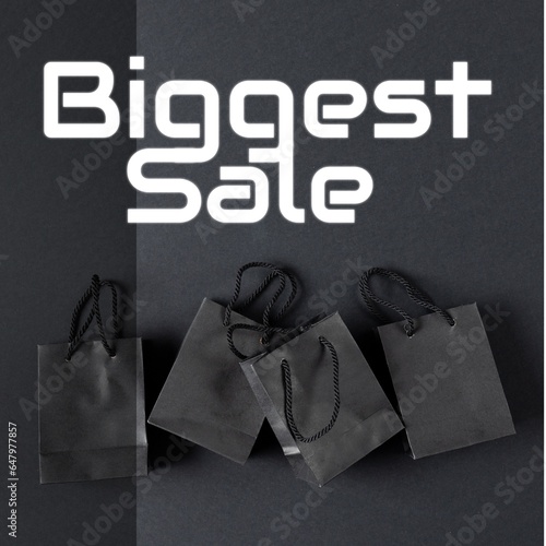 Biggest sale text in white over gift bags on dark grey background
