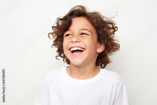  Studio portrait of cute little laughing boy on different colour background photo