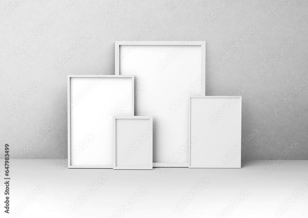 White plain empty blank five different sizes of vertical photo picture frames in front of textured concrete wall White plain empty blank five different sizes of vertical photo picture frames in front of textured concrete wall