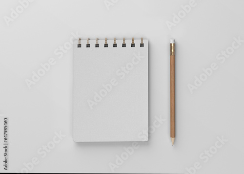 linen spiral notebook with pencil on a plain white blank empty background
