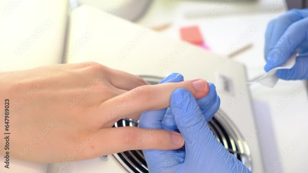 Nail care procedure in a beauty salon. Female hands and tools for manicure, process of