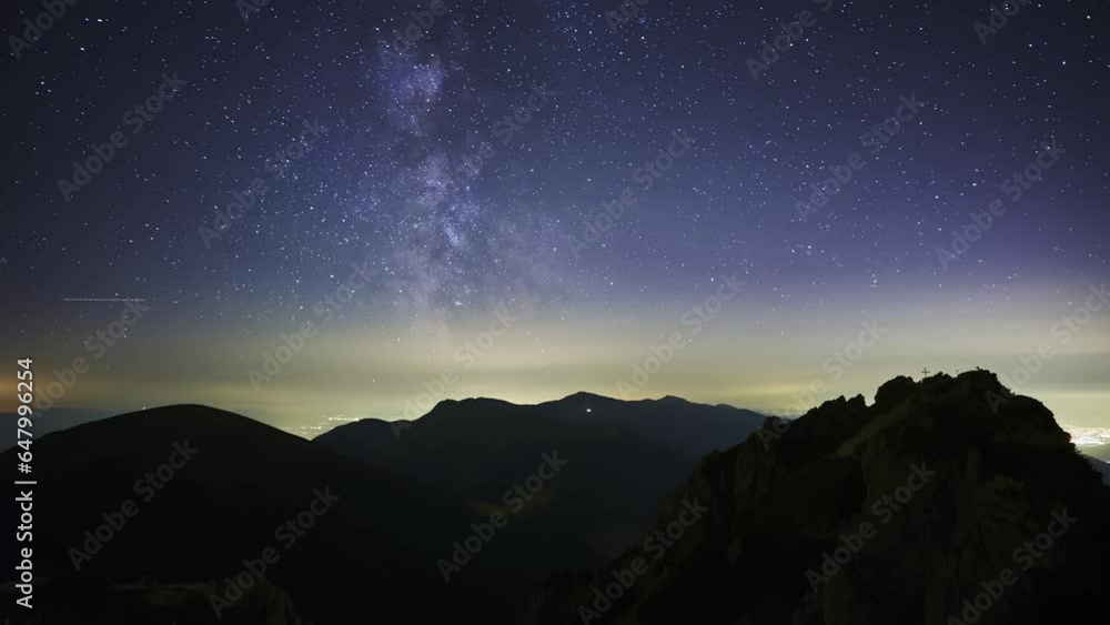 The stars of the Milky Way galaxy move above the mountain hills.4K The stars of the Milky Way galaxy move above the mountain hills.4K