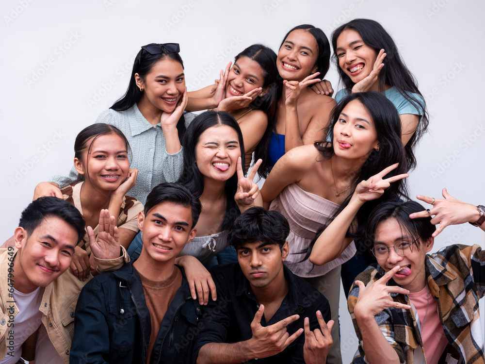 A diverse group of eleven young friends posing together looking happy. 6 women, 4 guys and 1 trans woman. Isolated on a white background. A diverse group of eleven young friends posing together looking happy. 6 women, 4 guys and 1 trans woman. Isolated on a white background.