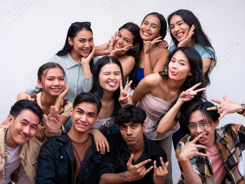 A diverse group of eleven young friends posing together looking happy. 6 women, 4 guys and 1 trans woman. Isolated on a white background.