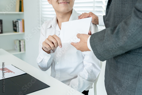 Businessmen receive salary or bonuses from management or Boss. Company give rewards to encourage work. Smiling businessman enjoying a reward at the desk in the offic photo