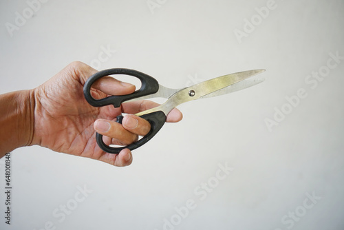 picture of asian man hand holding paper scissors isolated on white background