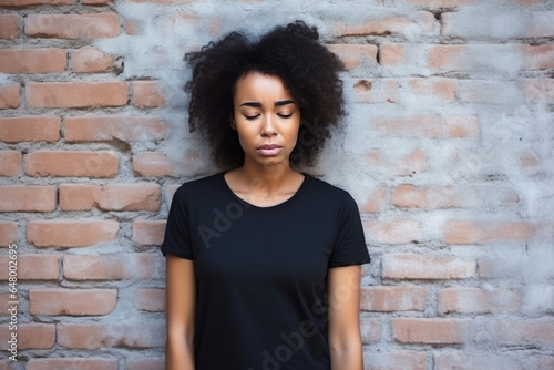 Sadness African Woman In A Black Tshirt On Brick Wall Background