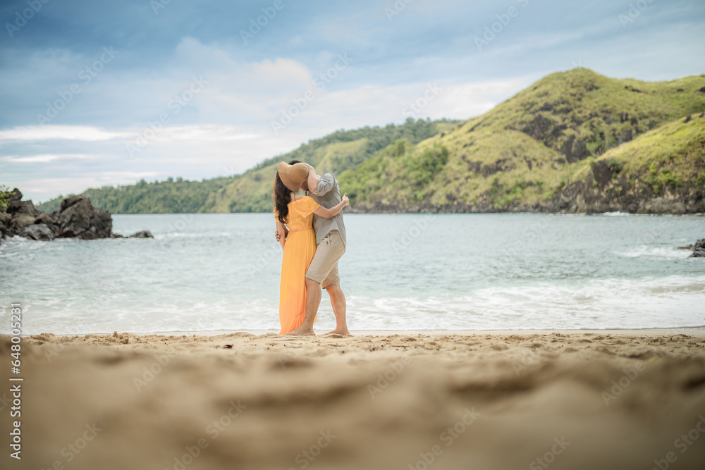 couple on the beach kissing