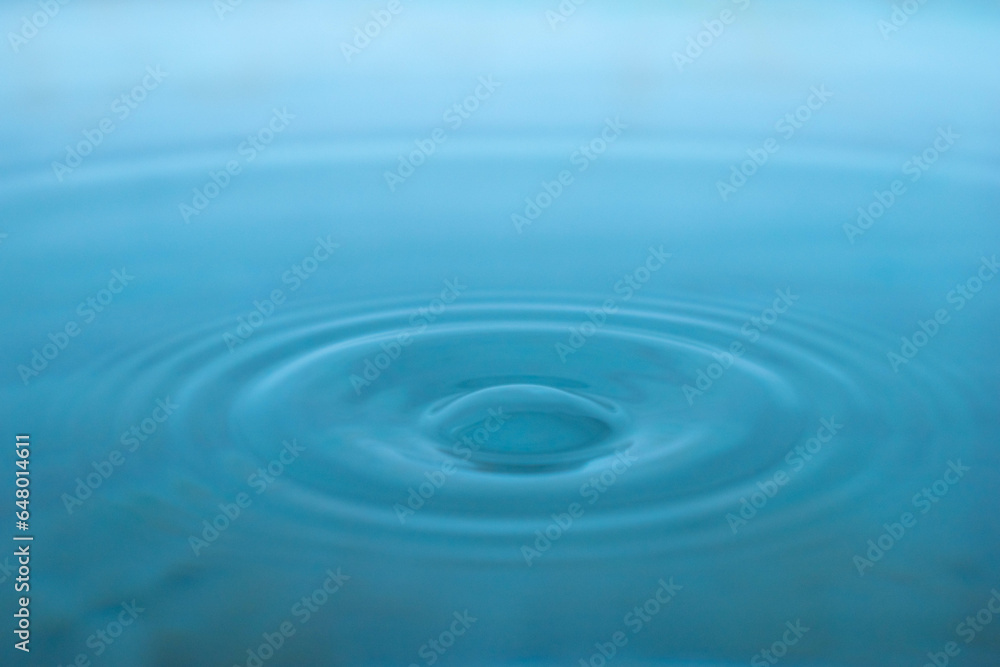Water drop. Close-up circle ripples on water surface. Clear Water drop with circular waves Water drop. Close-up circle ripples on water surface. Clear Water drop with circular waves