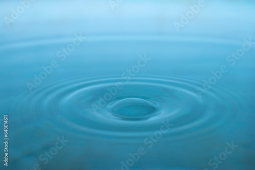 Water drop. Close-up circle ripples on water surface. Clear Water drop with circular waves